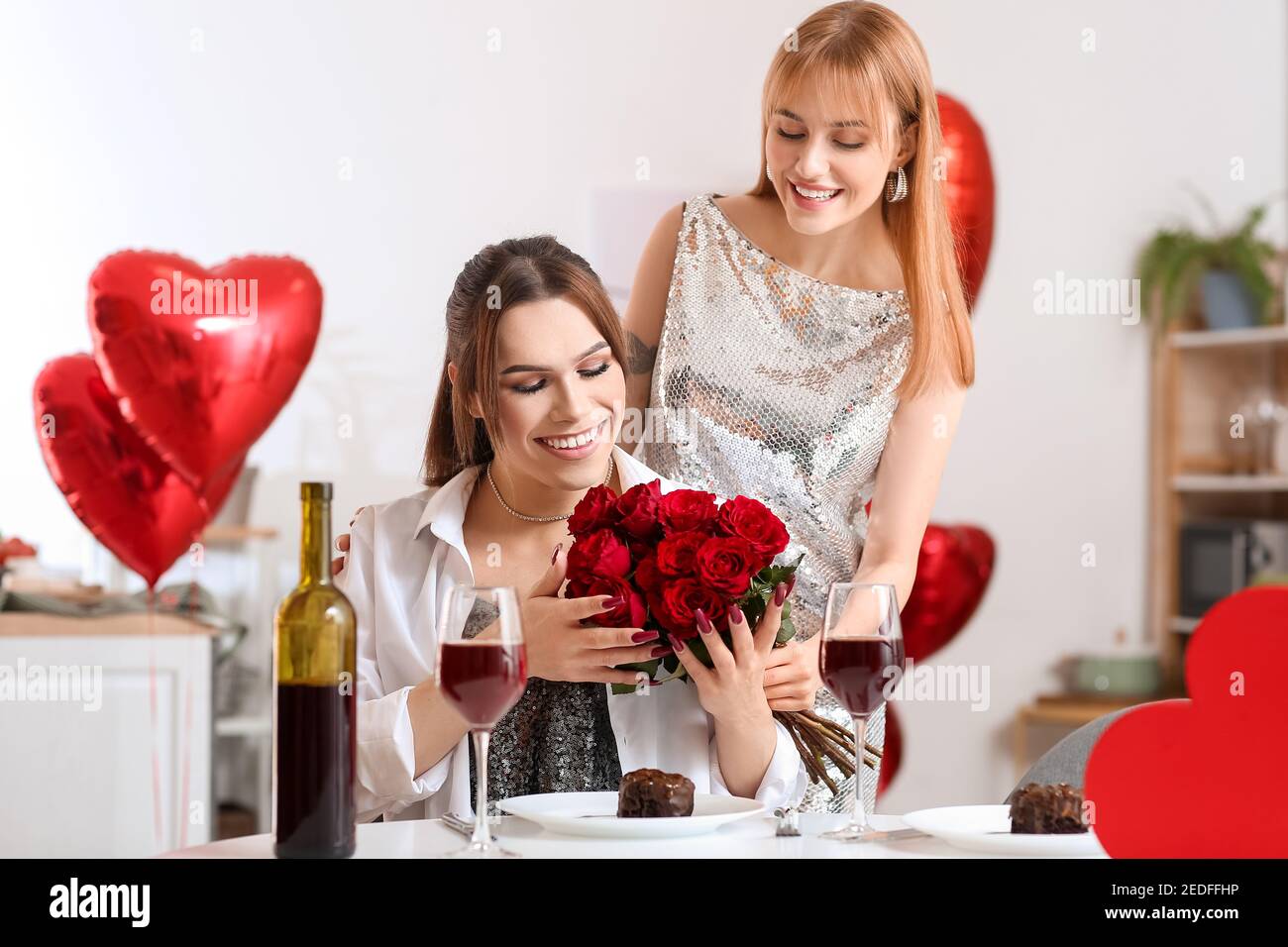 Happy transgender couple celebrating Valentine's Day at home Stock ...