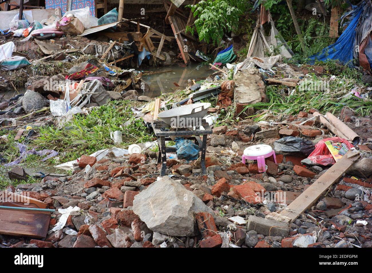 flash floods that destroyed dozens of houses and caused casualties. buildings destroyed after being hit by floods, storms, landslides in the rainy sea Stock Photo