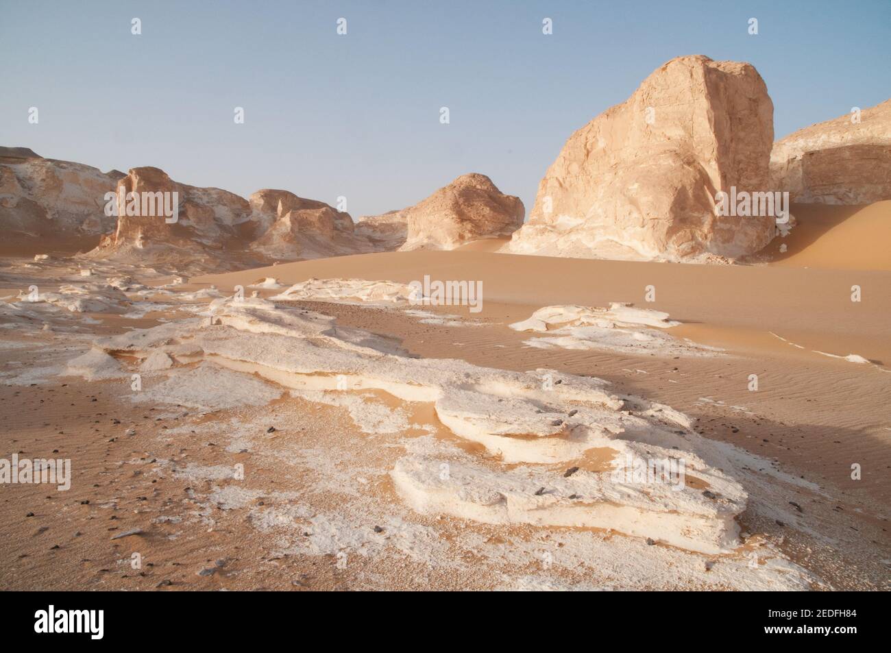 White chalk rock formations and inselbergs mixed with sand in White Desert National Park, in the Farfara Depression, Sahara region, of Egypt. Stock Photo