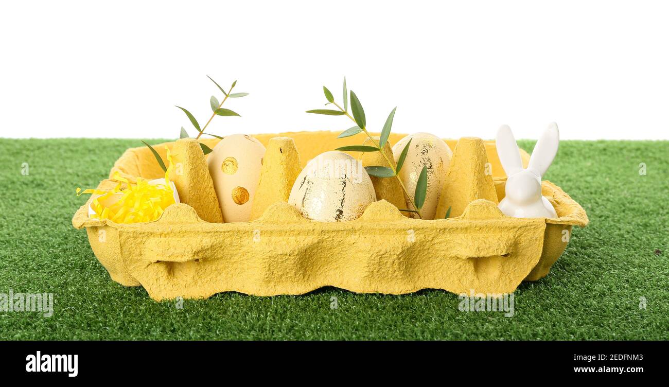 Easter eggs and bunny on grass against white background Stock Photo - Alamy