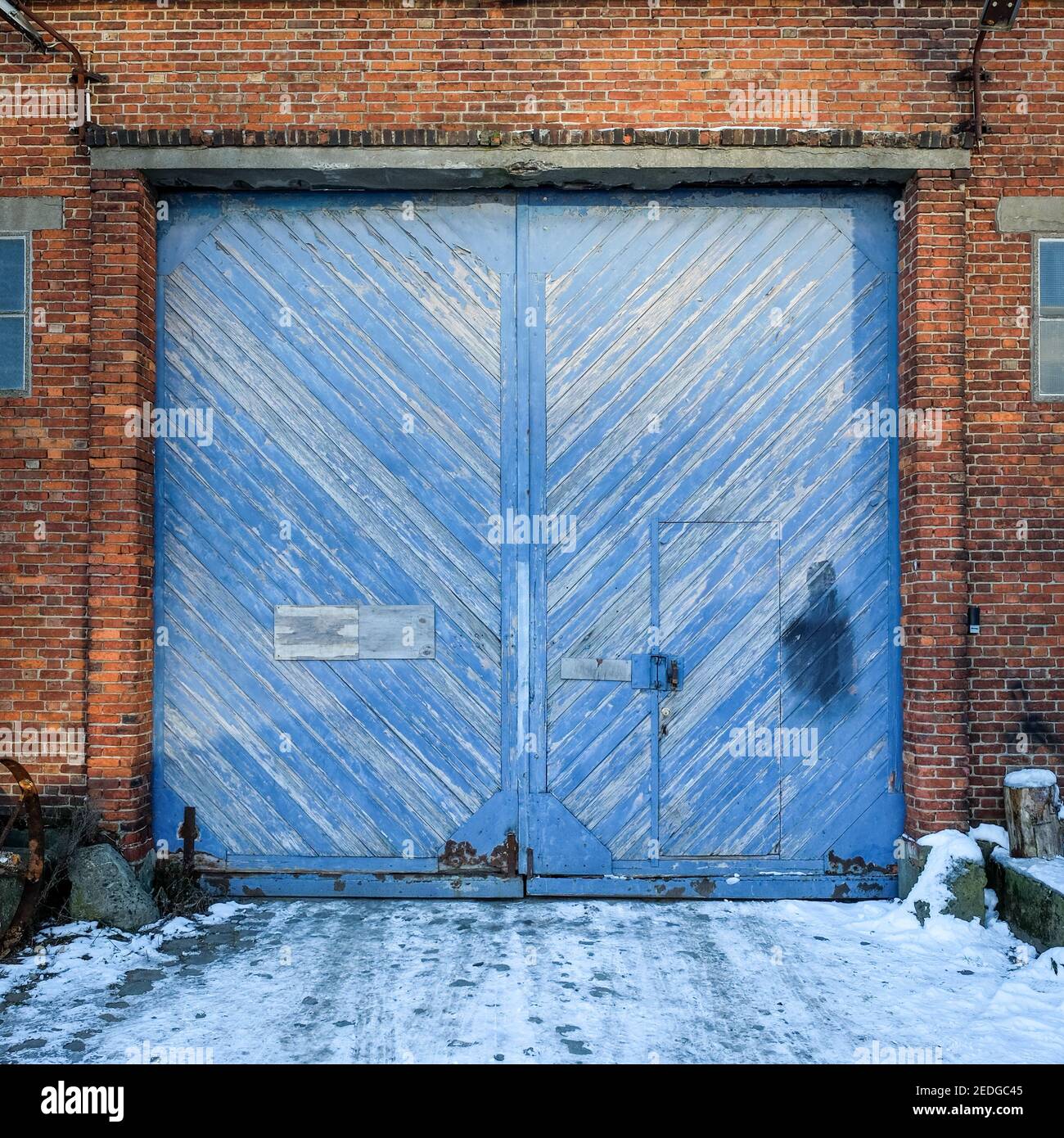 Blue wooden door of an old warehouse Stock Photo