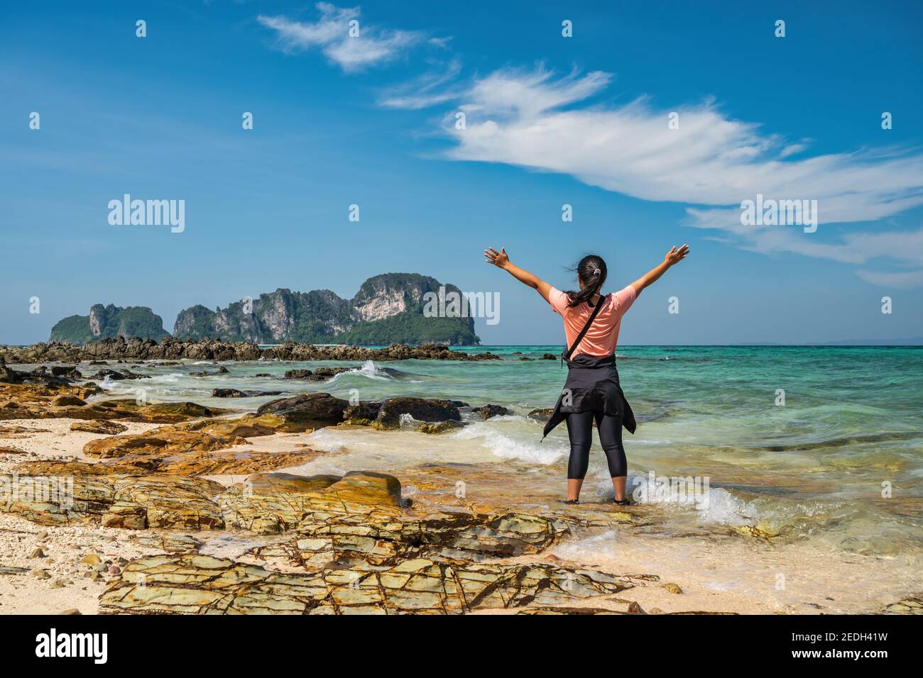 Tropical islands view with woman tourist looking at ocean blue sea water and white sand beach at Bamboo Island, Krabi Thailand nature landscape Stock Photo