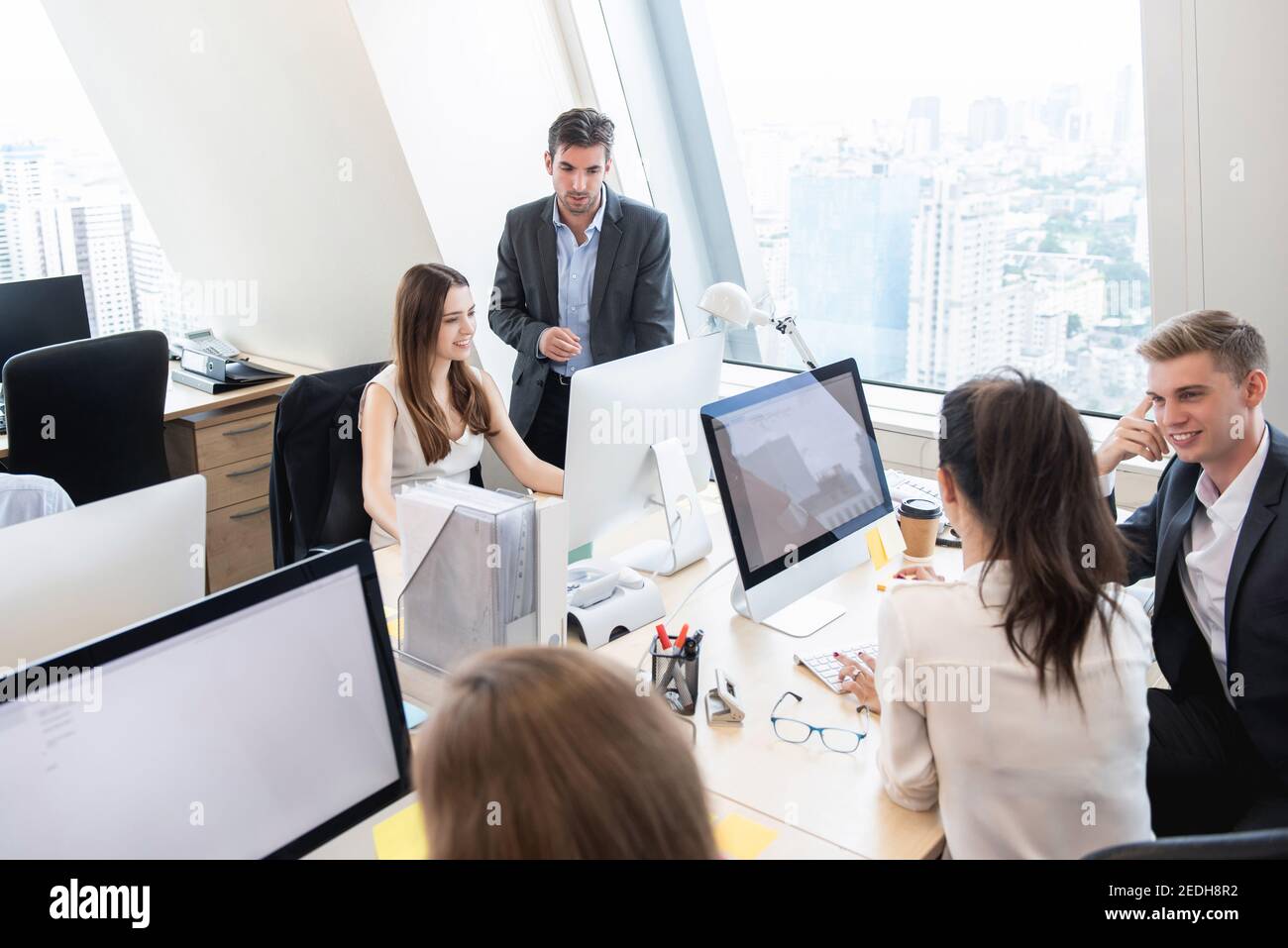 Group of business people working together in headquarters office on high rise buiding in the city Stock Photo