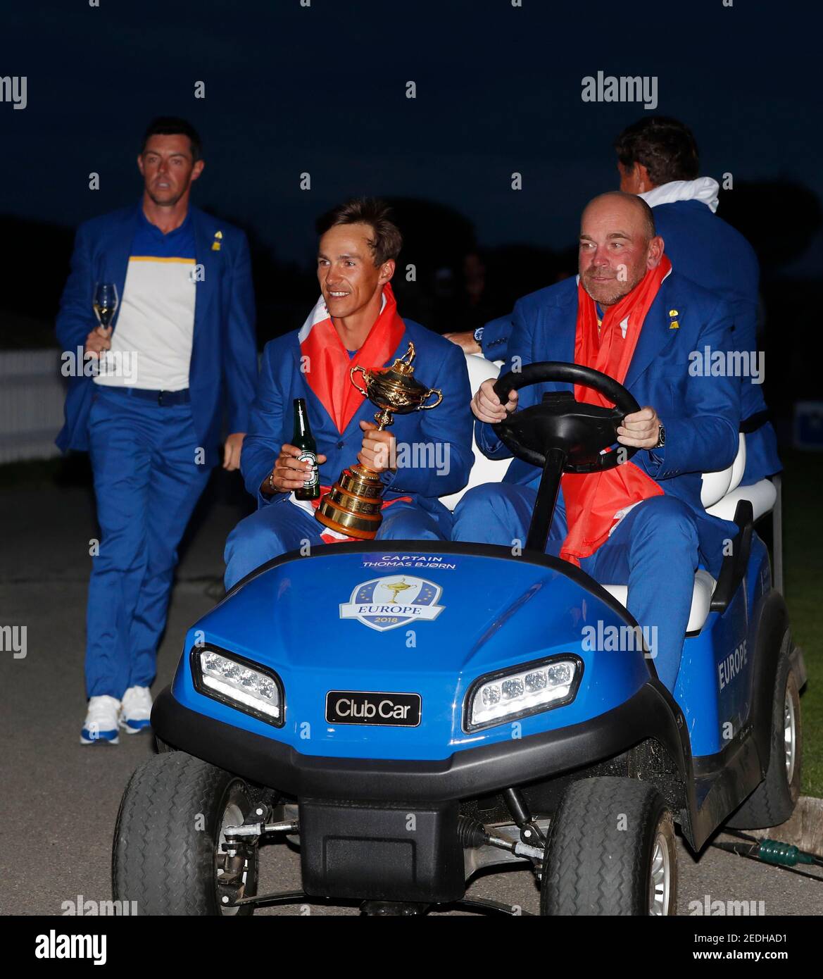 Golf - 2018 Ryder Cup at Le Golf National - Guyancourt, France - September  30, 2018. Team Europe's Thorbjorn Olesen and captain Thomas Bjorn celebrate  with the trophy on a golf buggy