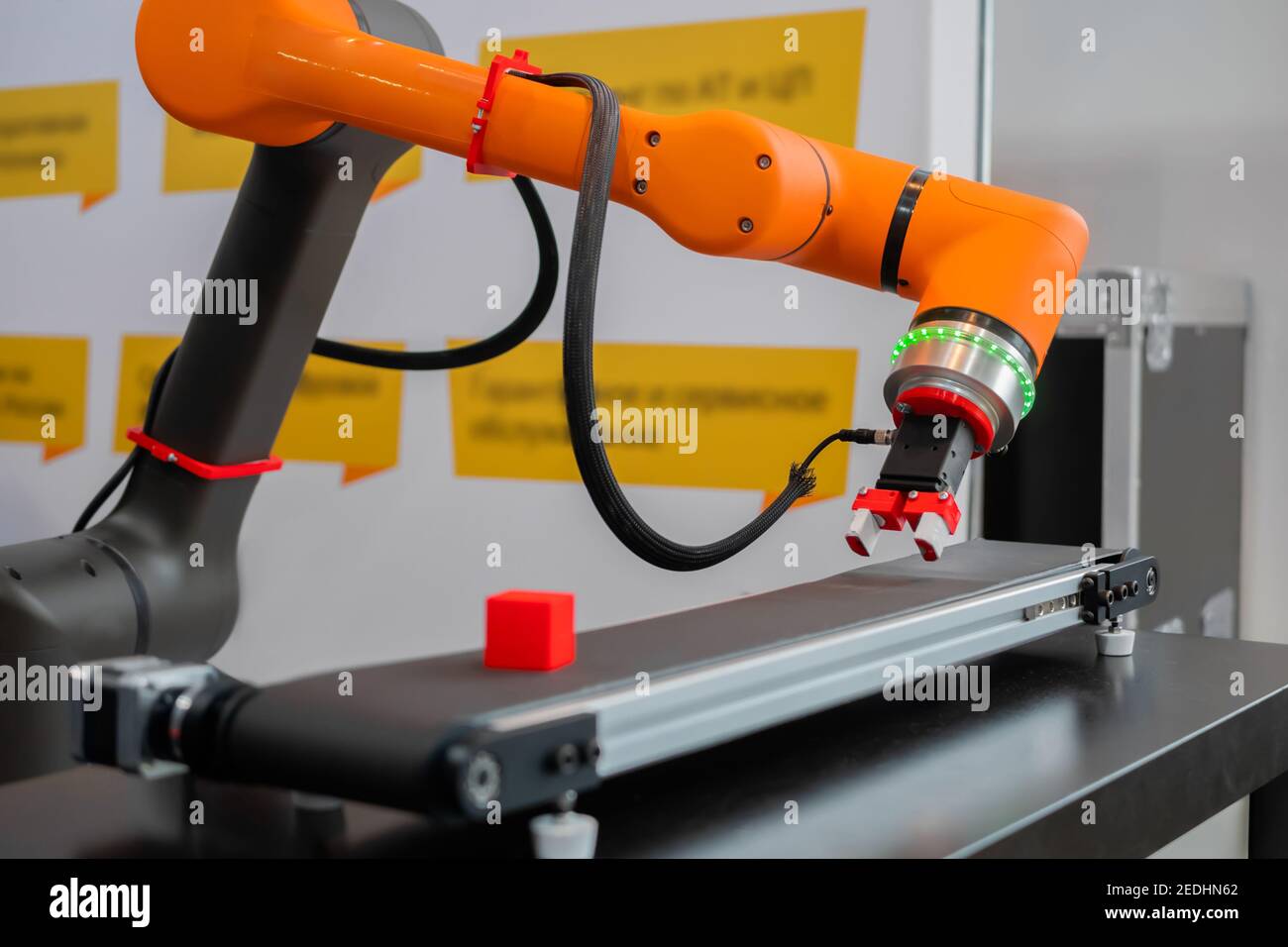Pick place robotic arm manipulator moving red toy blocks at robot Stock Photo - Alamy
