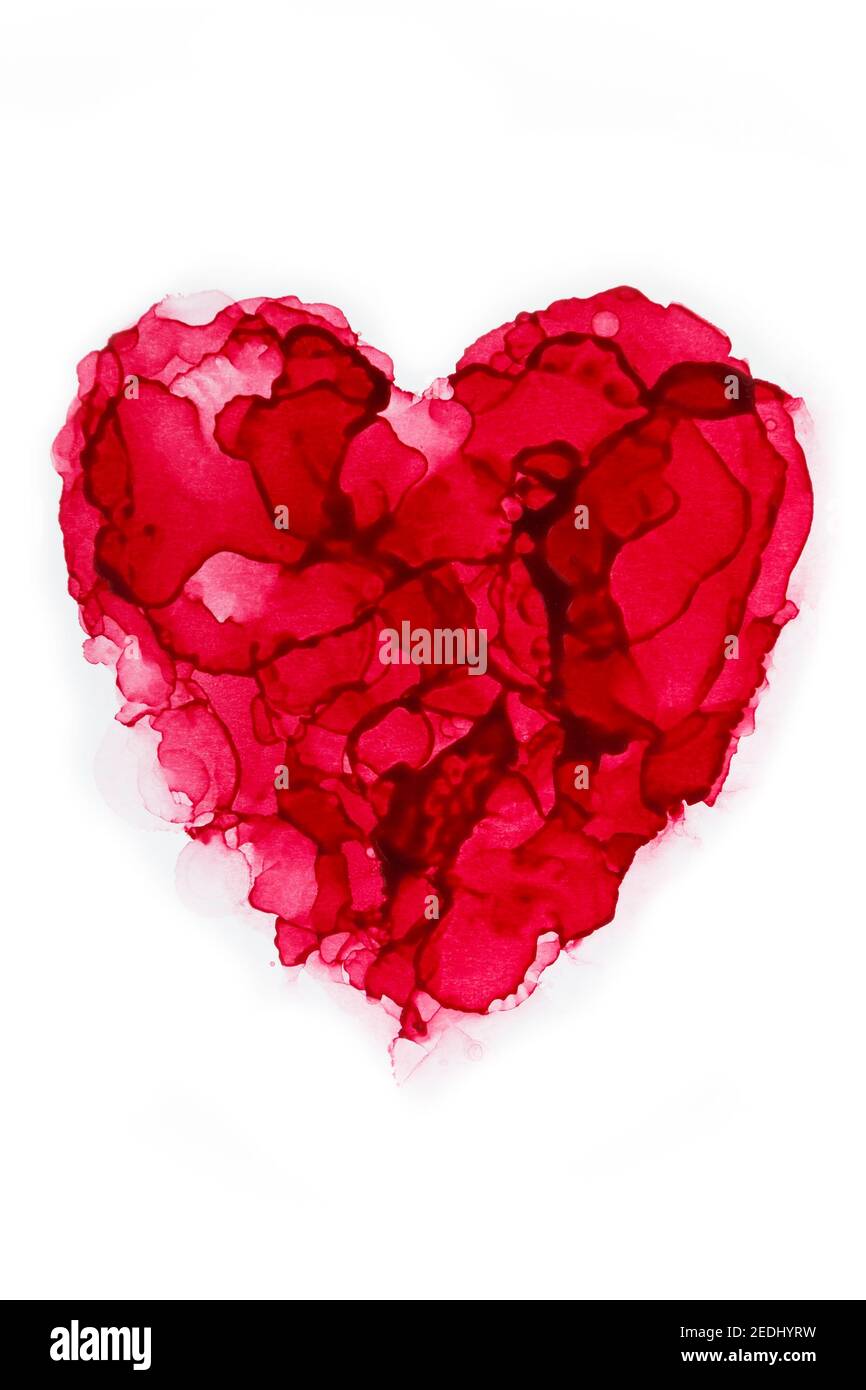 Macro close-up of a red heart shape painted with alcohol ink. Layers and splashes, abstract painting isolated on white. Fluid ink. Symbol of love. Stock Photo