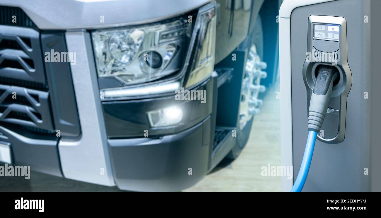 Electric truck with charging station. Concept Stock Photo