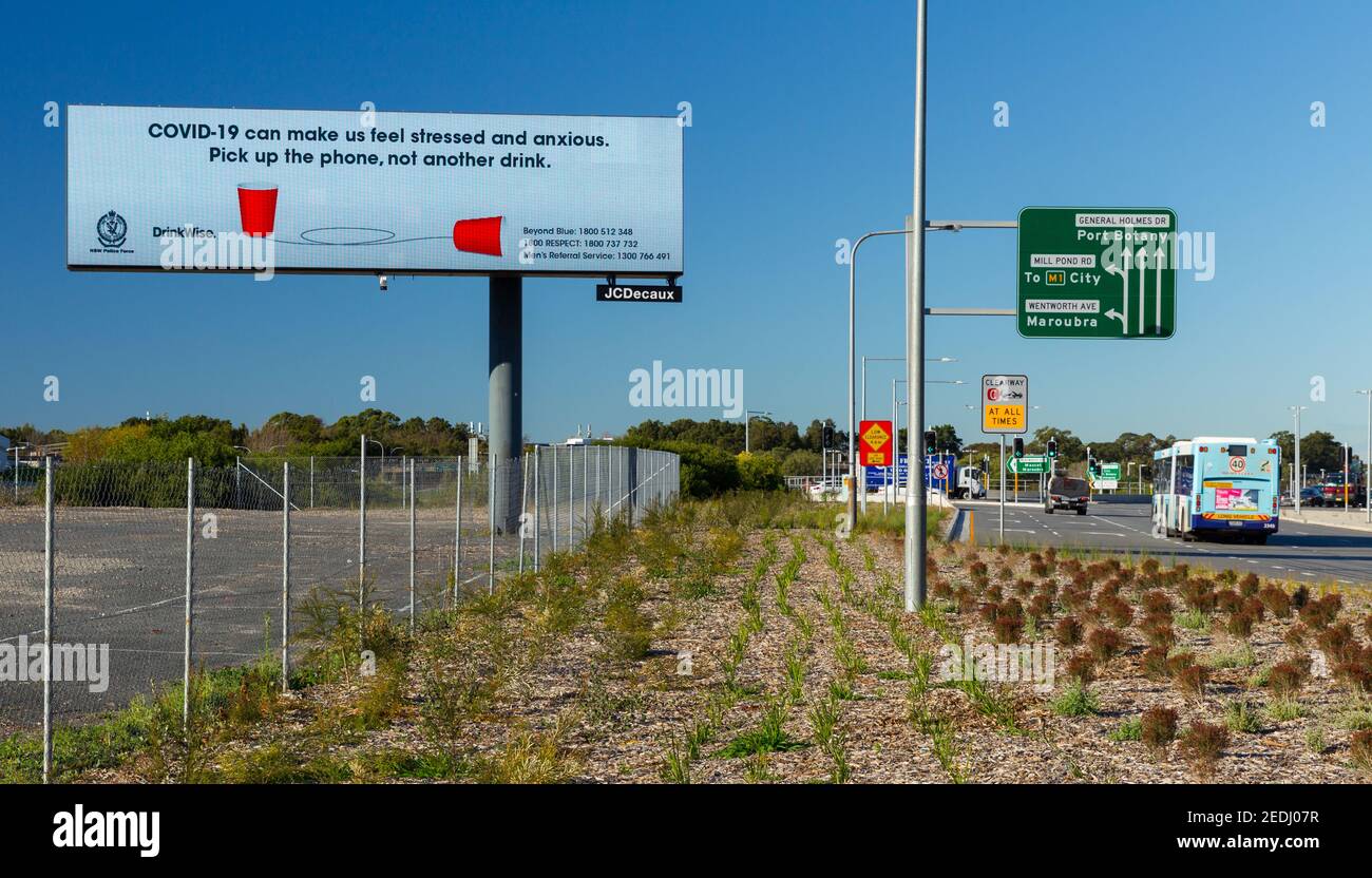 A roadside Coronavirus billboard on General Holmes Drive between the suburbs of Mascot and Botany Bay in Sydney, Australia, at Sydney Airport. Stock Photo