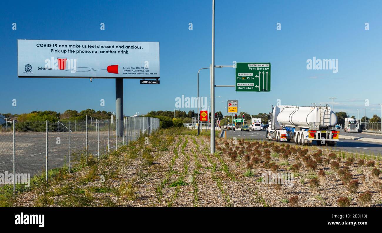 A roadside Coronavirus billboard on General Holmes Drive between the suburbs of Mascot and Botany Bay in Sydney, Australia, at Sydney Airport. Stock Photo