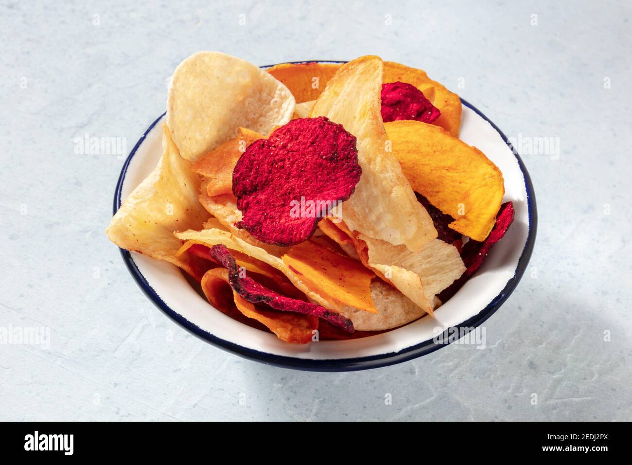 Fruit and vegetable chips in a bowl, a healthy vegan snack Stock Photo