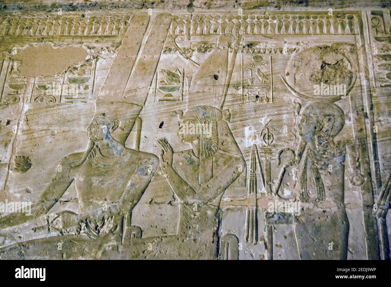 Frieze at the Temple of Seti I of the Ancient Egyptian gods Amun Ra, Isis and Ptah. West bank of the River Nile at Luxor, Egypt. Stock Photo