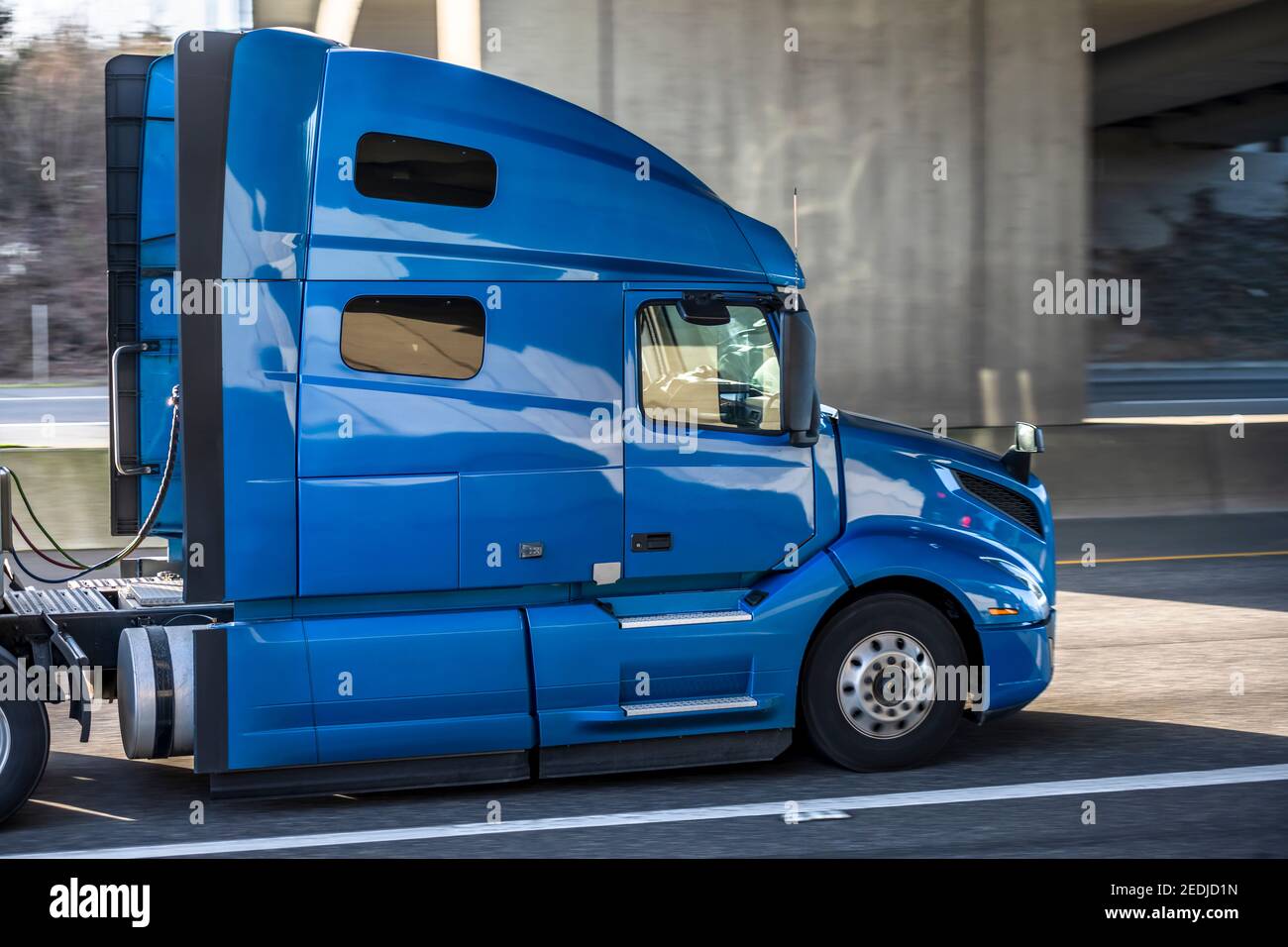 Classic powerful big rig blue semi truck tractor with sleeping compartment  and roof spoiler transporting commercial cargo in dry van semi trailer mov  Stock Photo - Alamy