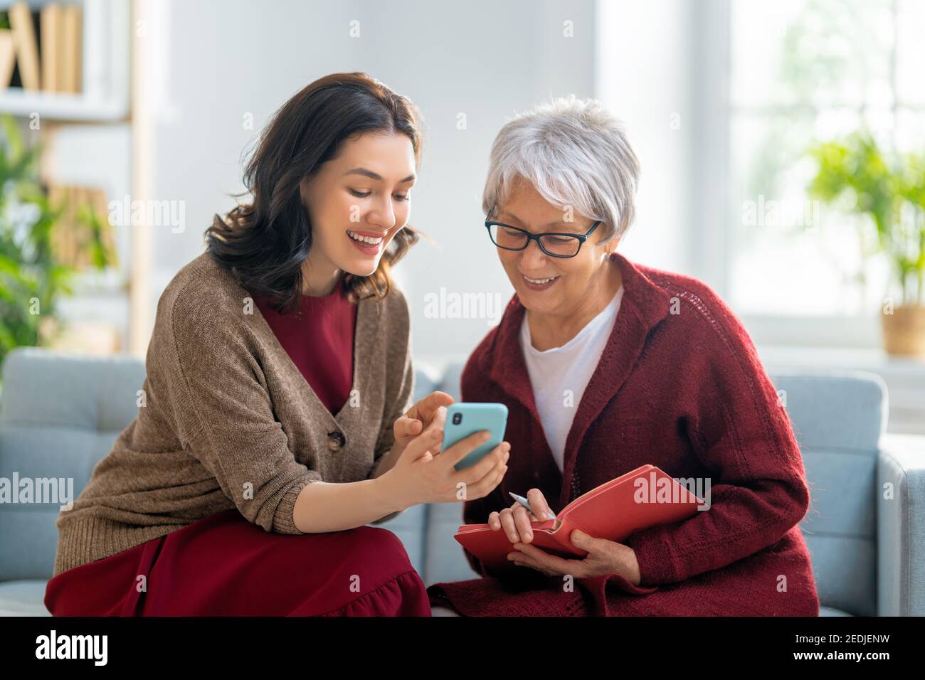 Download this stock image: Young and senior women are using smartphone .