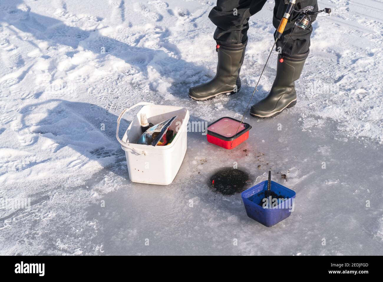 At the ice hole ice fishing Stock Photo Alamy