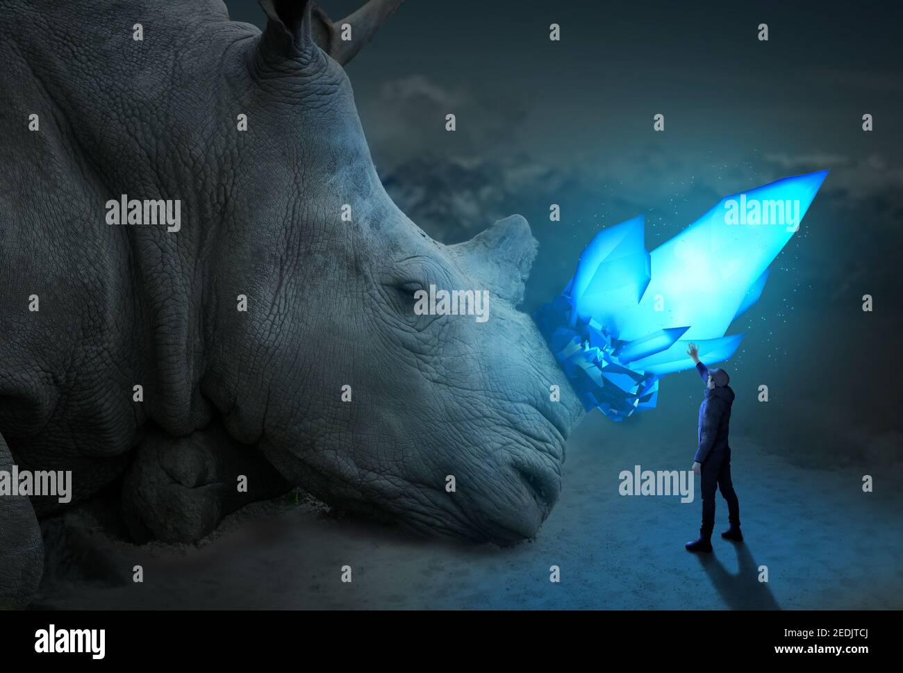 Man has unreal encounter with giant Rhino, blue glowing crystal Stock Photo