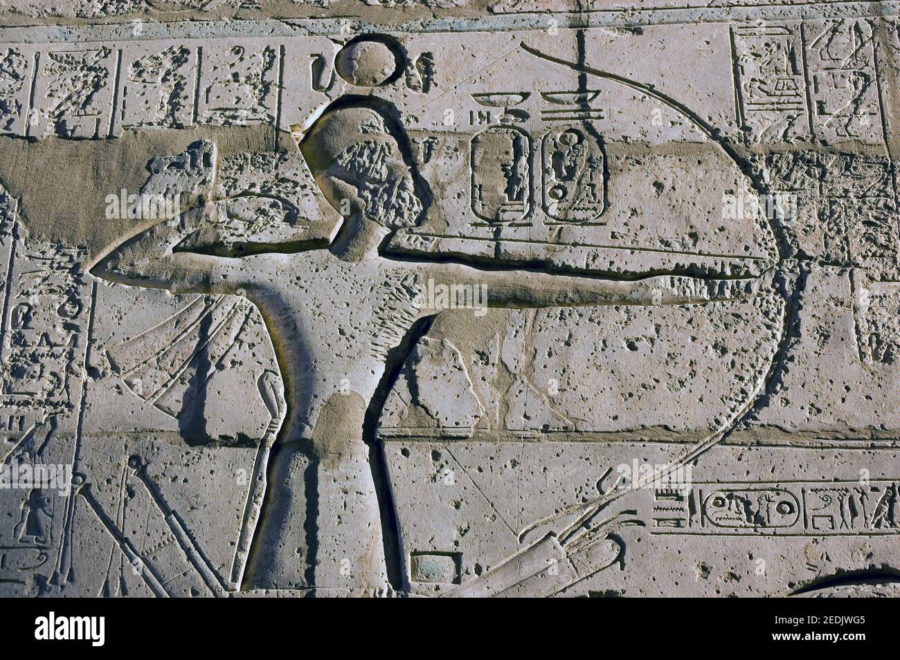 Stone carved frieze of the Ancient Egyptian Pharaoh Ramses II firing a bow and arrow. Second pylon of the Ramesseum at Luxor, Egypt. Stock Photo