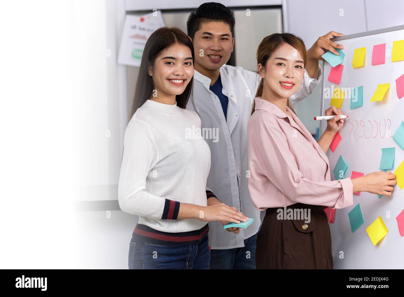 Business Team brainstorm meeting. Group of business people working at Private Home Office. Business team using post-it paper on whiteboard. business w Stock Photo