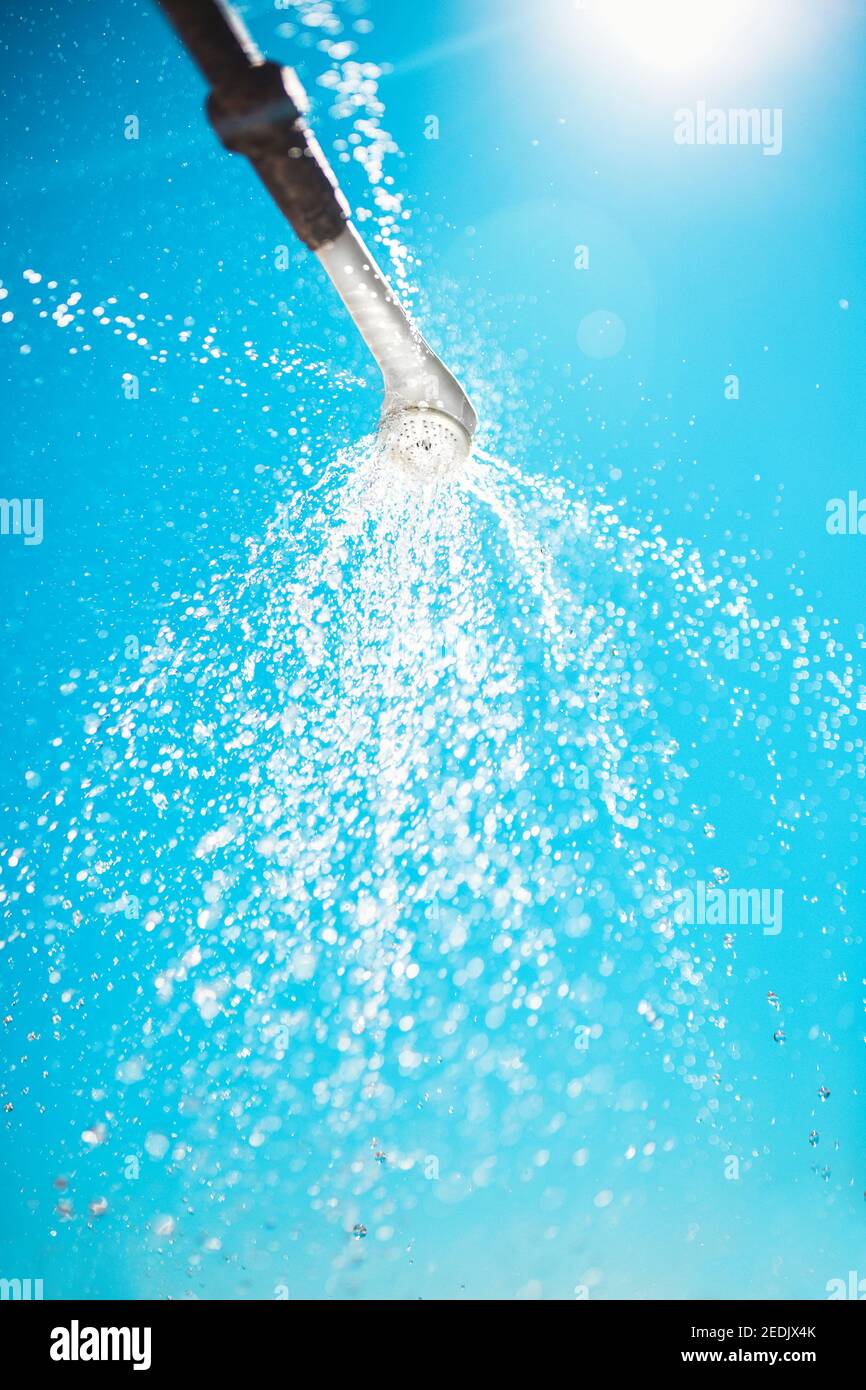 Fresh cool shower in hot sunny weather summer shower against the sky