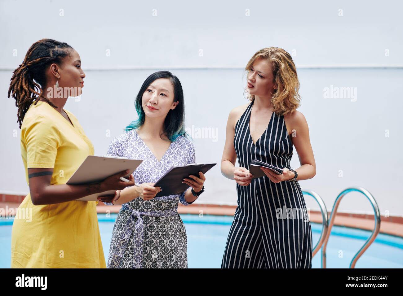 Talking female colleagues Stock Photo