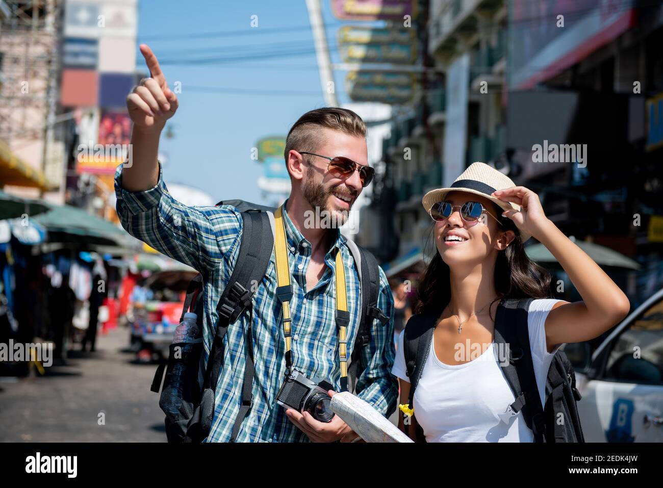 Interracial tourist backpacker couple traveling in Bangkok Thailand on summer vacations Stock Photo