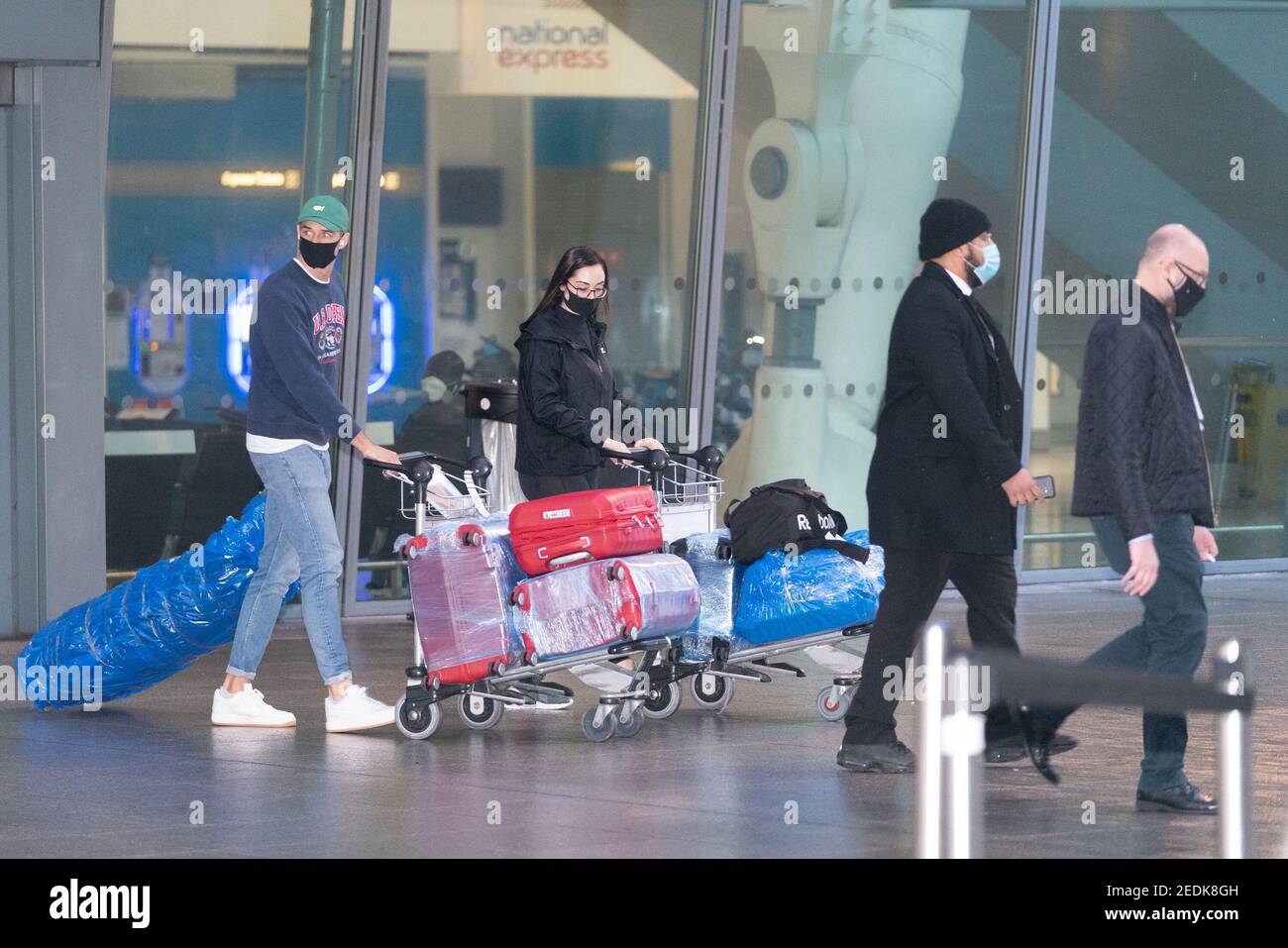 Passengers arrive at London Heathrow's Terminal 5 on the first flight to the airport from one of 33 'red list' countries to which new mandatory coronavirus rules apply, before heading to a 10 day quarantine in a Government-designated hotel. Picture date: Monday February 15, 2021. Stock Photo