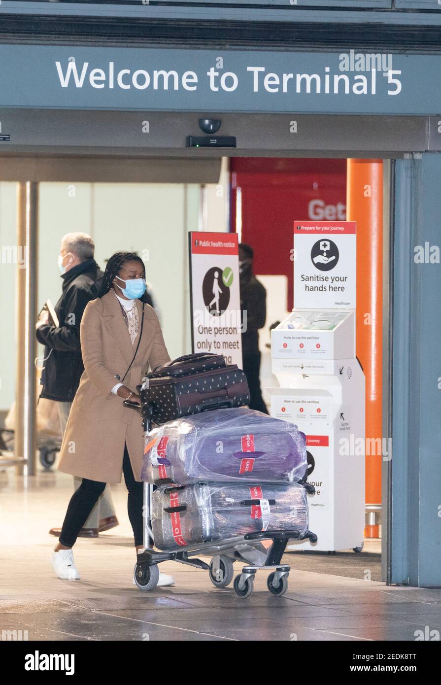 Passengers arrive at London Heathrow's Terminal 5 on the first flight to the airport from one of 33 'red list' countries to which new mandatory coronavirus rules apply, before heading to a 10 day quarantine in a Government-designated hotel. Picture date: Monday February 15, 2021. Stock Photo