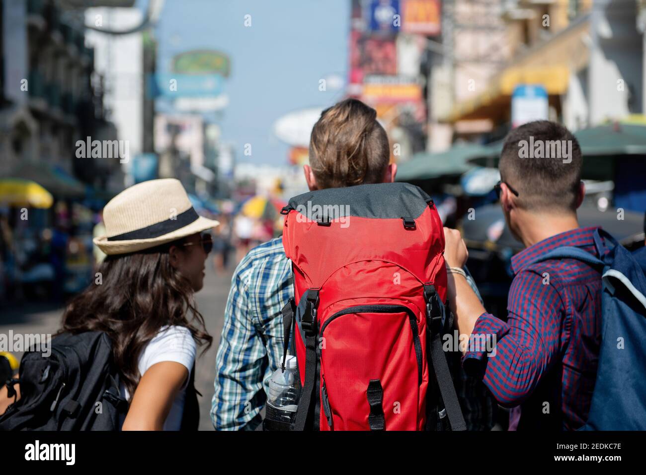 Tourist backpacker friends finding direction to their hostel while