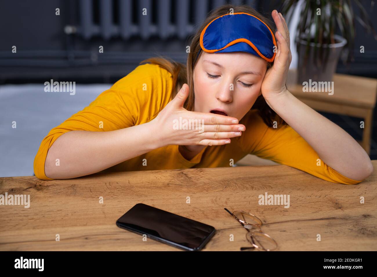 Sleepy emaciated woman lying on the floor late at night cannot sleep