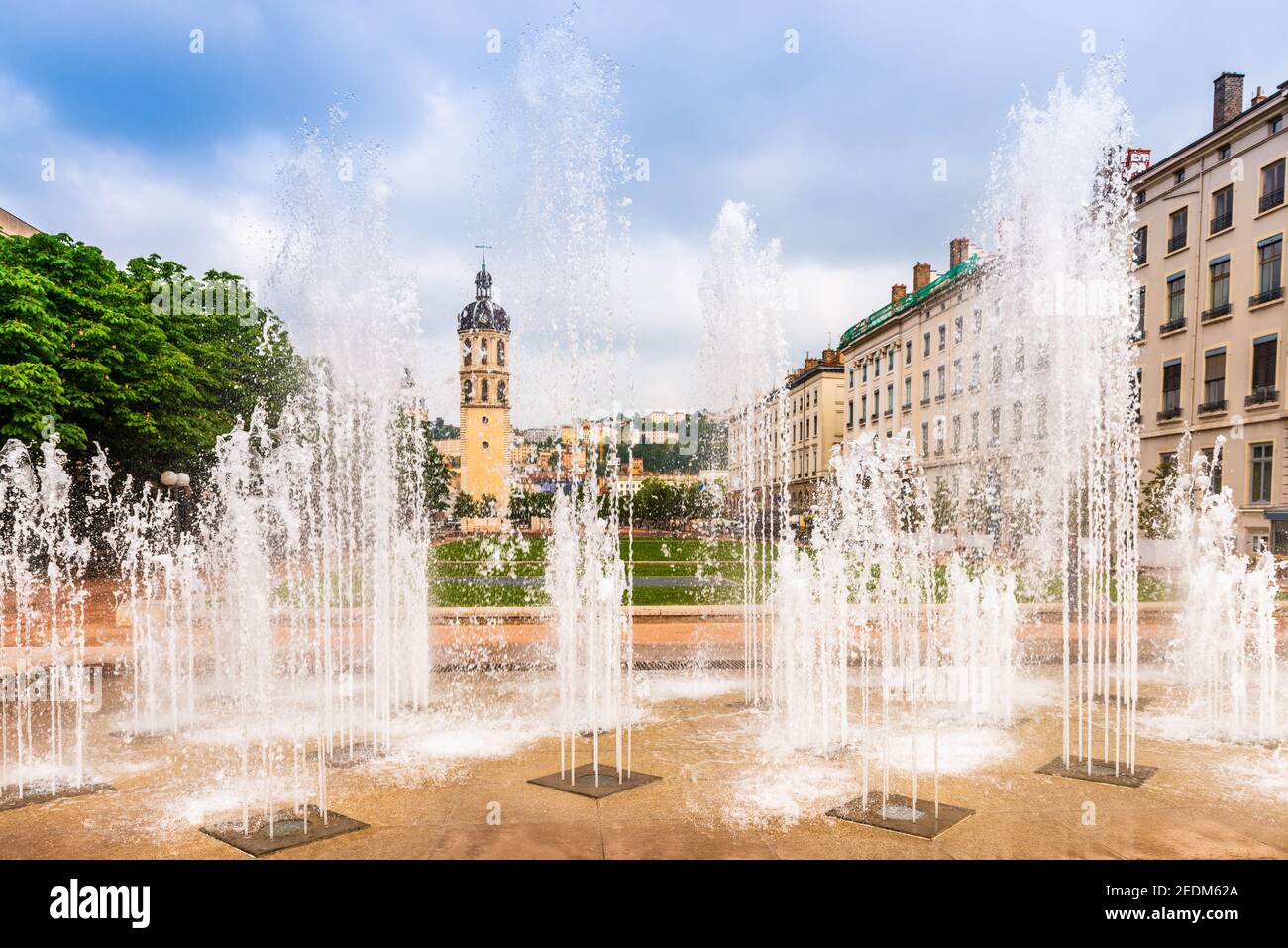 Place Antonin Poncet and its fountain, and the bell tower of charity in the background in Lyon, in the Rhône, France Stock Photo