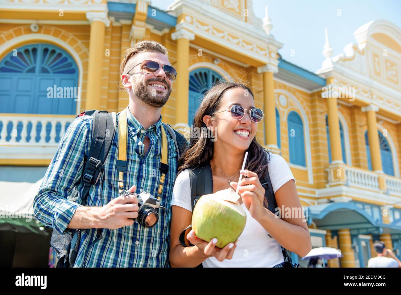 Young interracial couple tourist backpackers enjoying traveling in Bangkok city Thailand on summer holidays Stock Photo