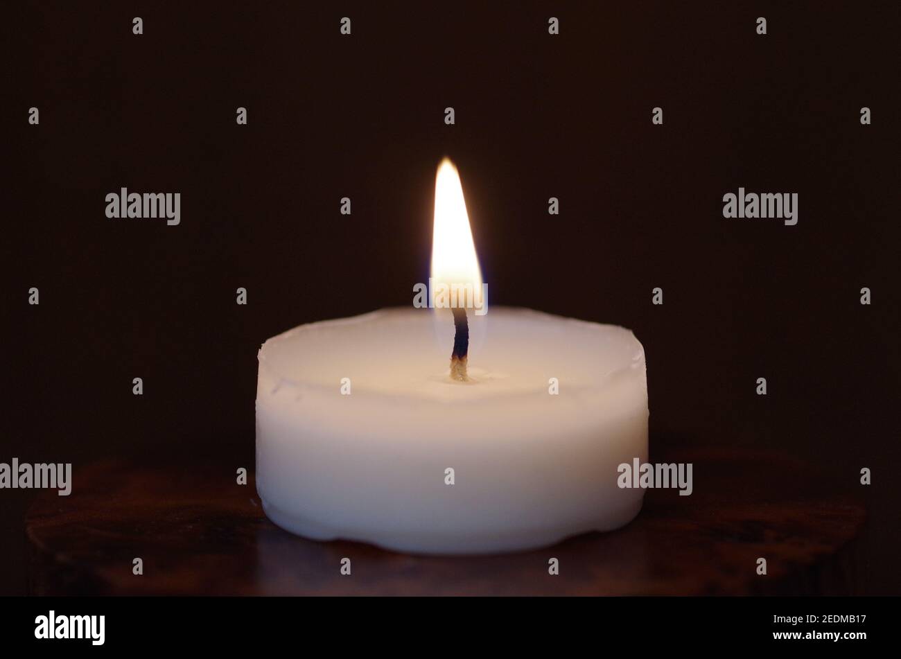 White burning  tea light candle Stock Photo