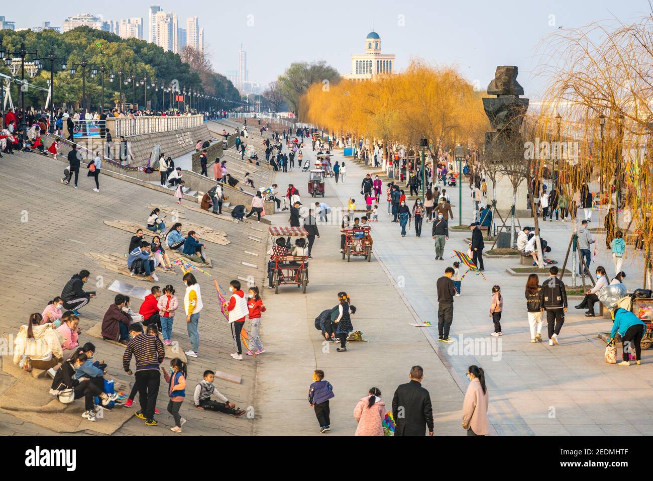 Wuhan China , 14 February 2021 : Crowd of people enjoying 2021 Chinese new year week holidays on Yangtze riverbanks in Wuhan Hubei China Stock Photo