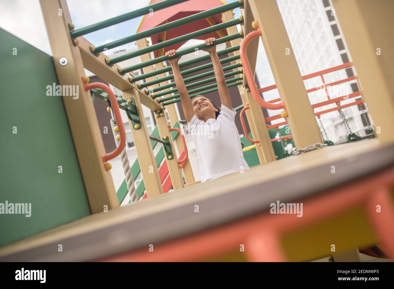 Cute boy in a white tshirt on a playground Stock Photo