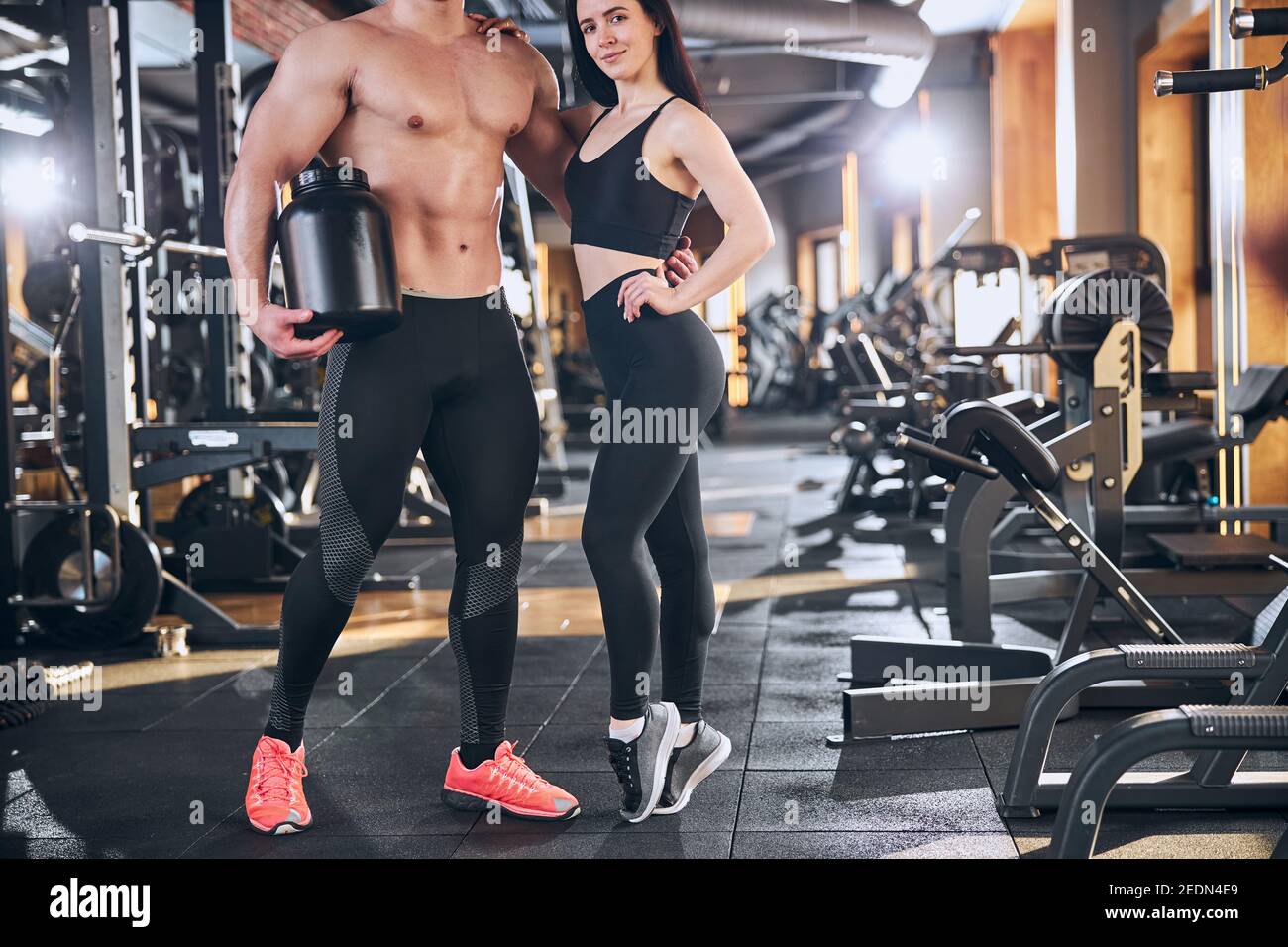 Sporty man and woman training together in gym Stock Photo - Alamy