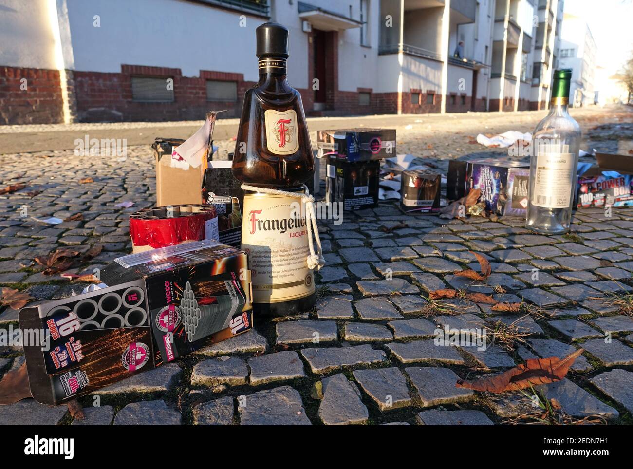 02.01.2020, Berlin, Saxony, Germany - New Year's Eve fireworks packaging and bottles on a pavement.. 00S200102D297CAROEX.JPG [MODEL RELEASE: NO, PROPE Stock Photo