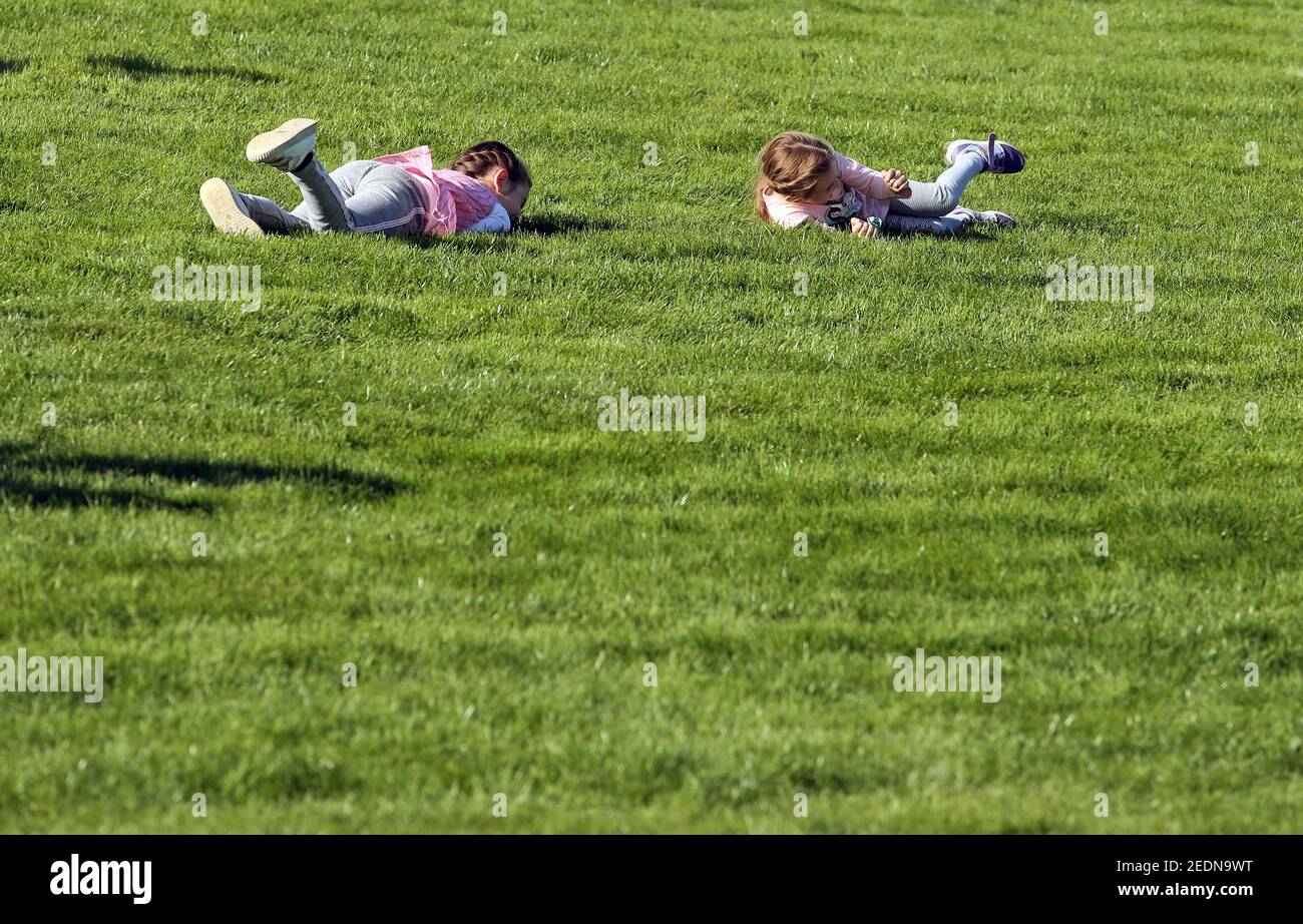 20.09.2020, Hannover, Lower Saxony, Germany - Little girls roll down a grassy slope.. 00S200920D453CAROEX.JPG [MODEL RELEASE: NO, PROPERTY RELEASE: NO Stock Photo