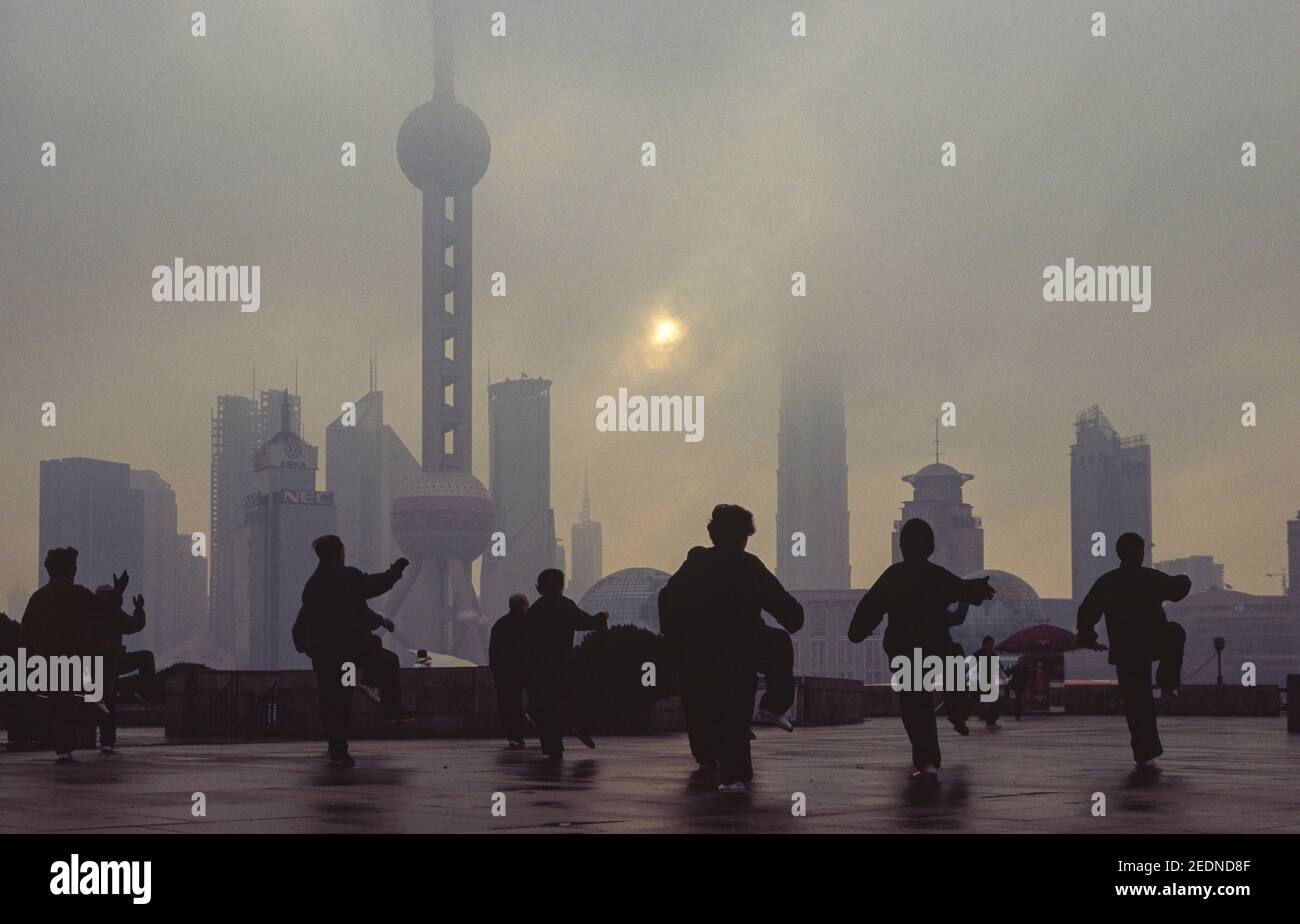 05.03.2011, Shanghai, , China - Tai Chi exercises in the early morning with a view from the Bund over the Huangpu River to the skyline of the business Stock Photo