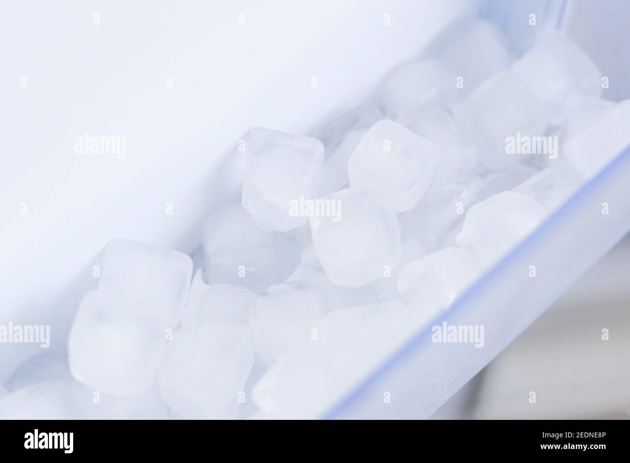 A Woman Opens An Ice Maker Tray In The Freezer To Take Ice Cubes To Cool  Drinks. Stock Photo, Picture and Royalty Free Image. Image 147627293.