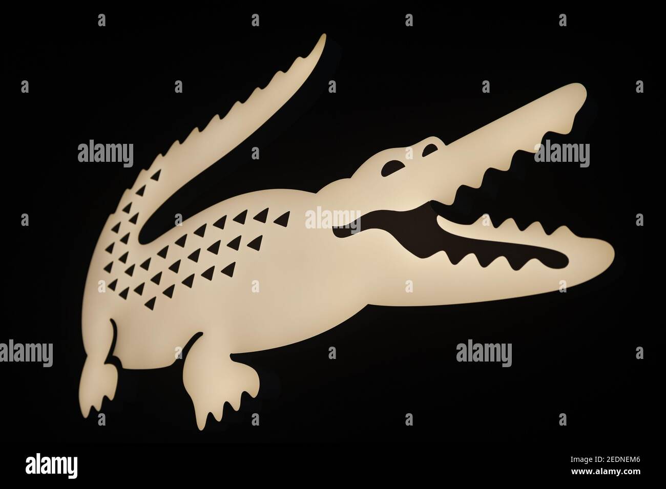 21.01.2021, Singapore, , Singapore - Illuminated corporate logo of iconic  brand and fashion label Lacoste featuring the famous crocodile at a shop in  Stock Photo - Alamy