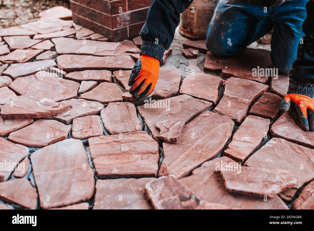 Facing with imitation of natural stone tiles of various shapes and sizes with selection
