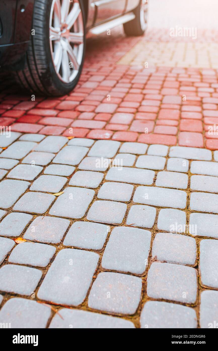 Car on paving slabs a durable road surface for the courtyard Stock