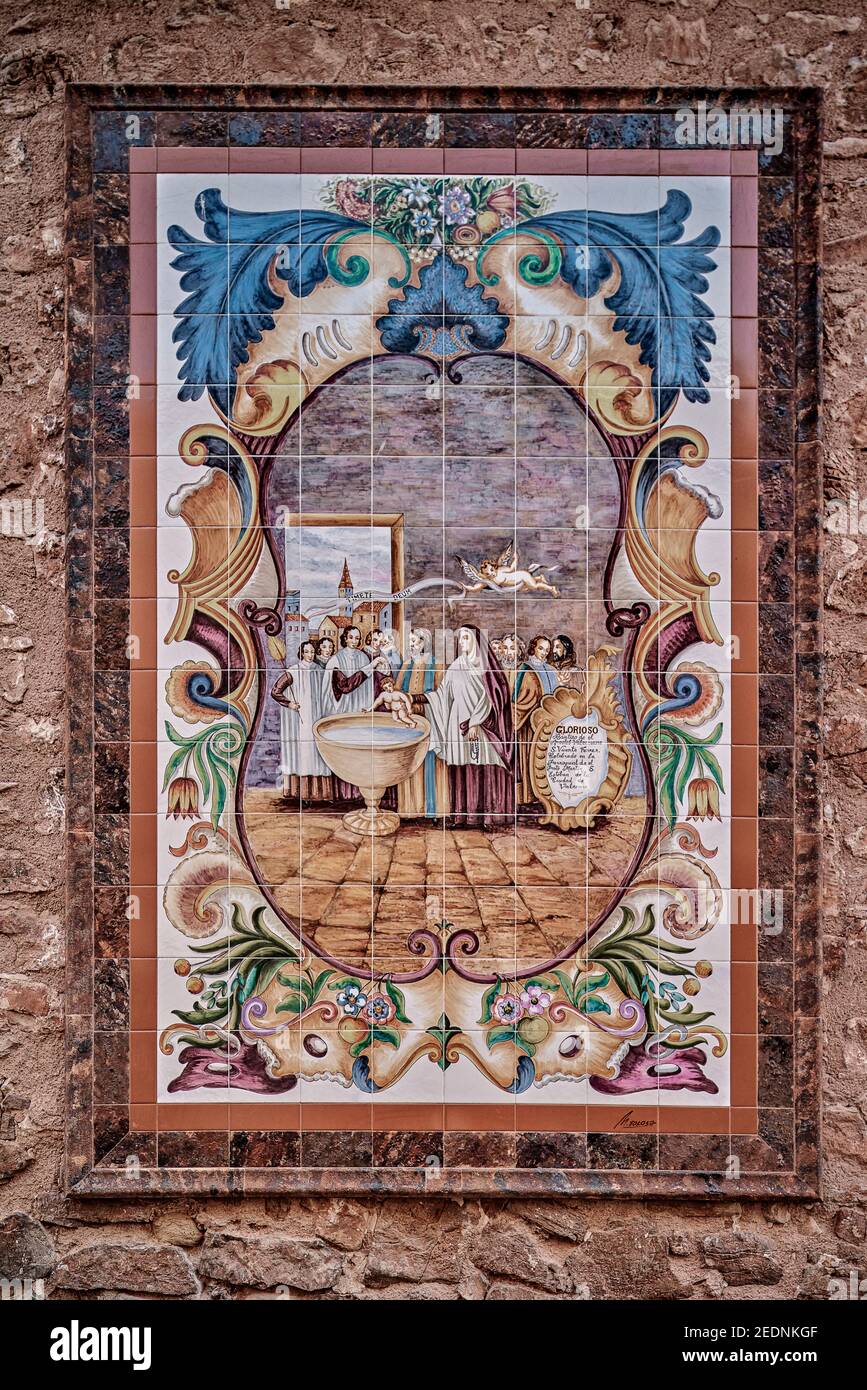 allegory of the baptism of San Vicente Ferrer glazed flat tile on the wall of the hermitage in Vall de Uxo, Castellon, Spain Stock Photo