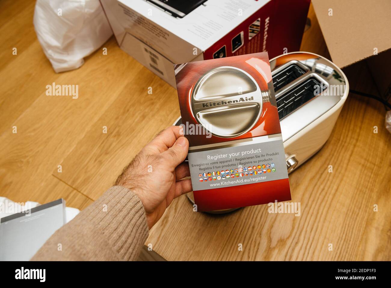Paris, France - Feb 1, 2021: Overhead view of male hand holding Warranty  Register your product card above the new KitchenAid toaster luxury product  with 2 compartments long slices Stock Photo - Alamy
