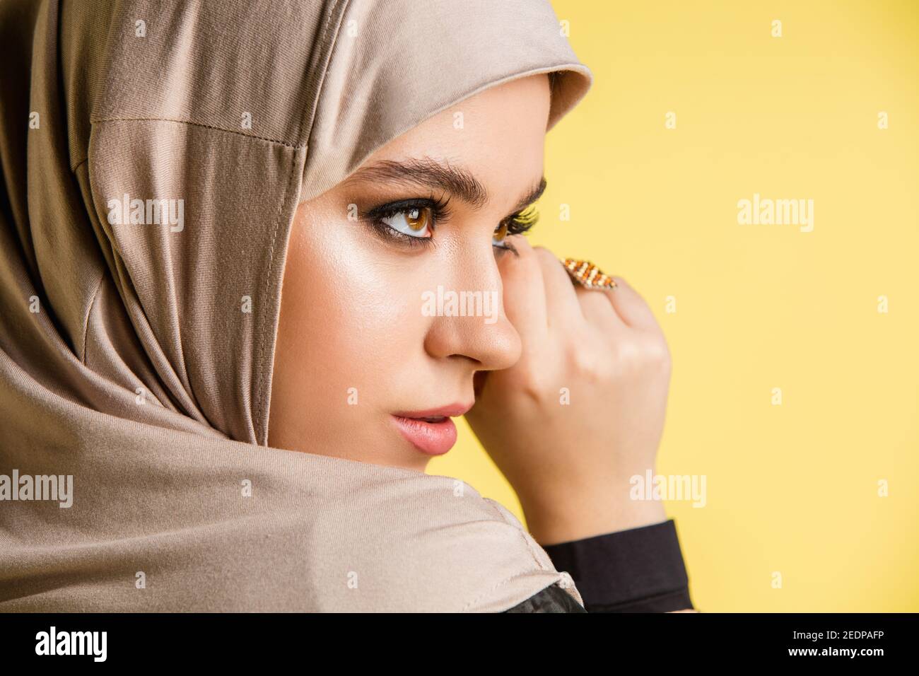 Eye shadow. Beautiful young arab woman in stylish hijab isolated