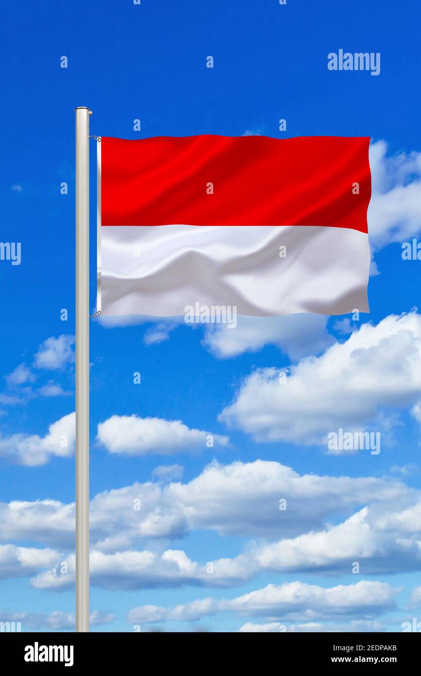 flag of Indonesien against blue cloudy sky, Indonesia Stock Photo