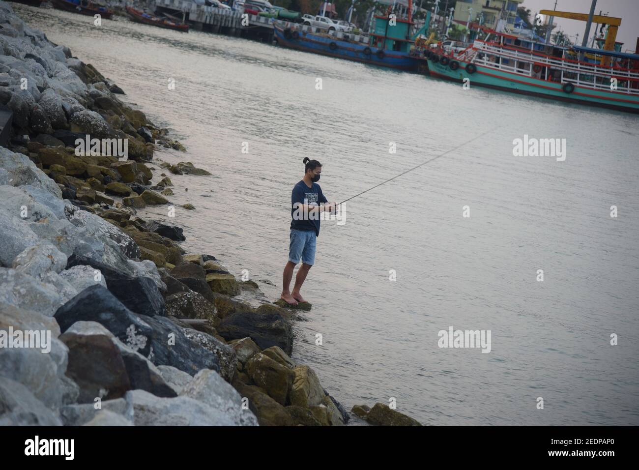a-man-fishing-at-the-pattaya-beach-pattaya-is-a-city-on-thailand-s