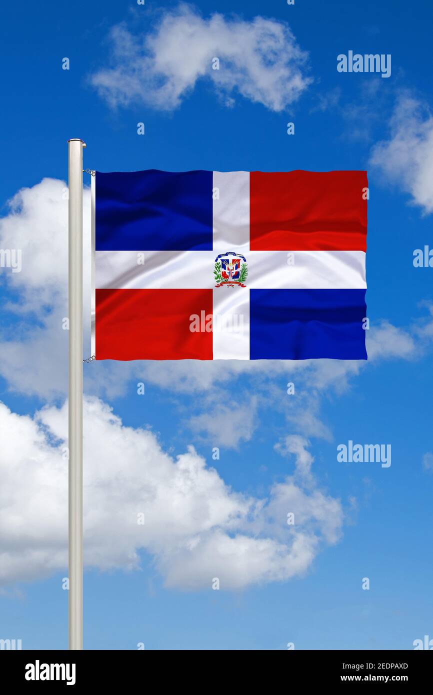 flag of Dominican Republic, Hispaniola against blue cloudy sky, Dominican Republic, Hispaniola Stock Photo