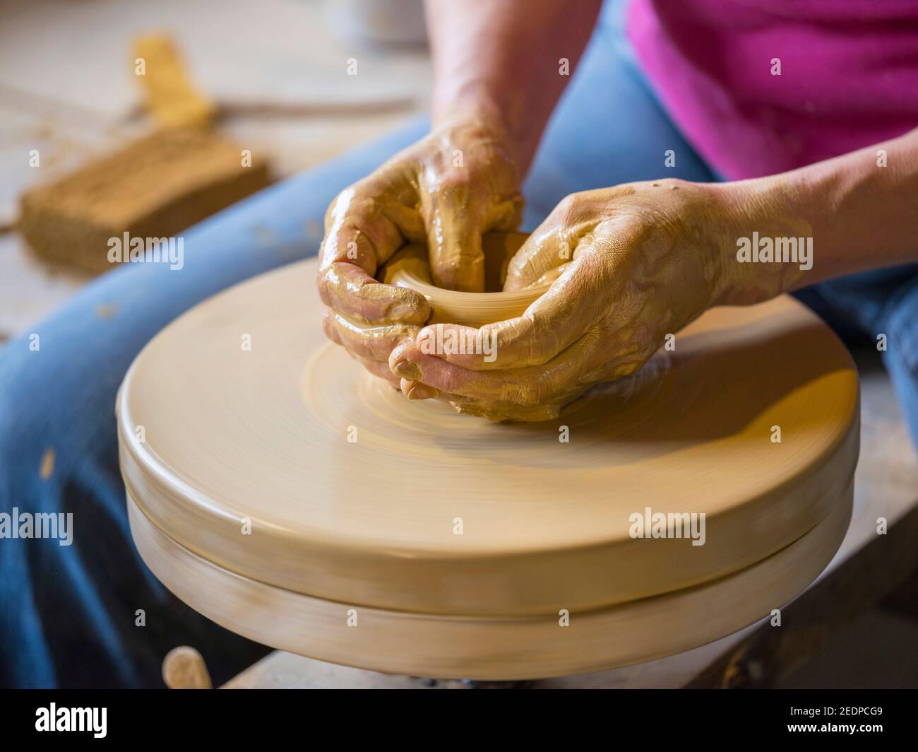 female potter shaping a vase from clay in a pottery workshop , Germany Stock Photo