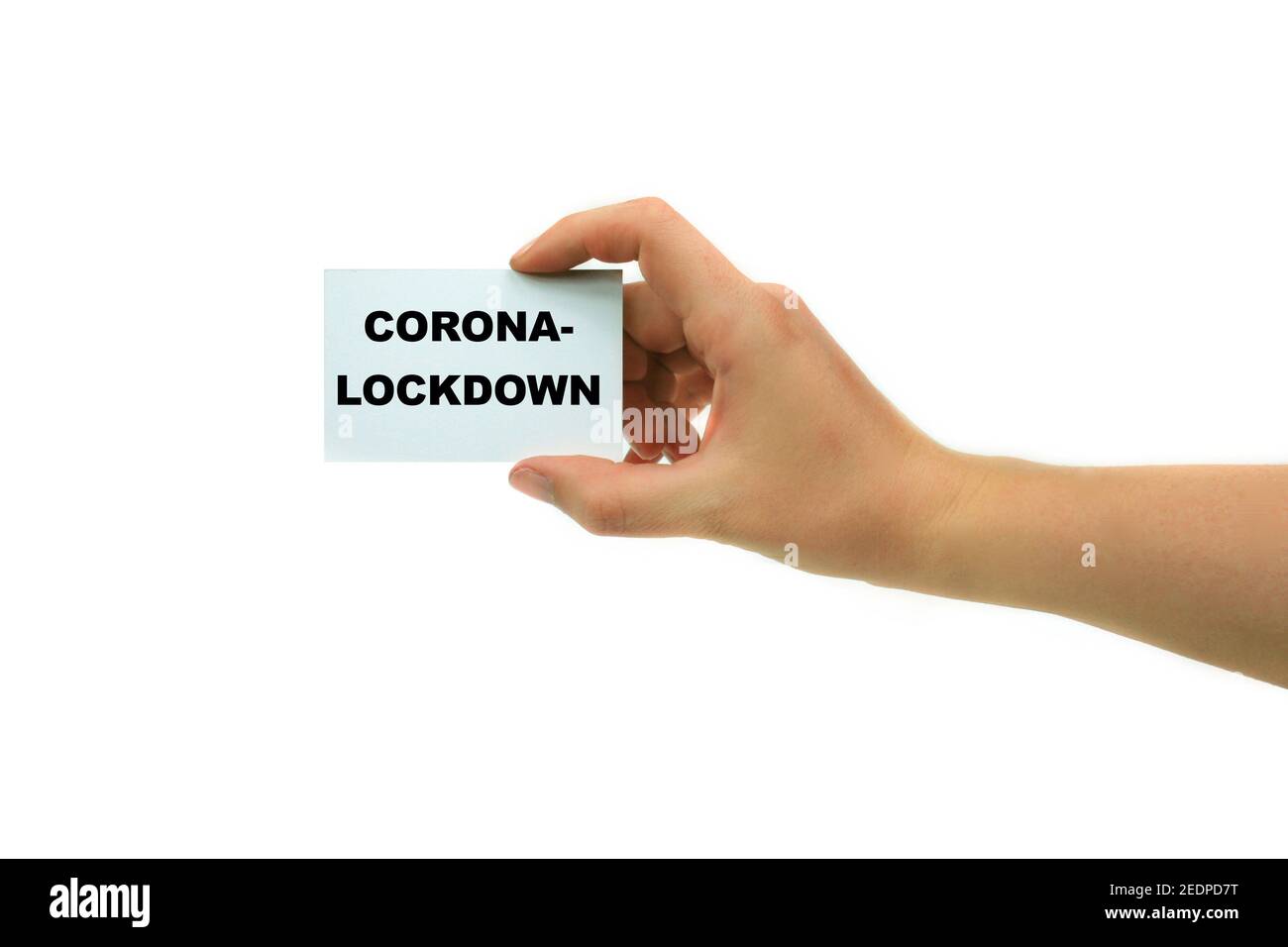 hand with visiting card lettering Corona-Lockdown, Germany Stock Photo