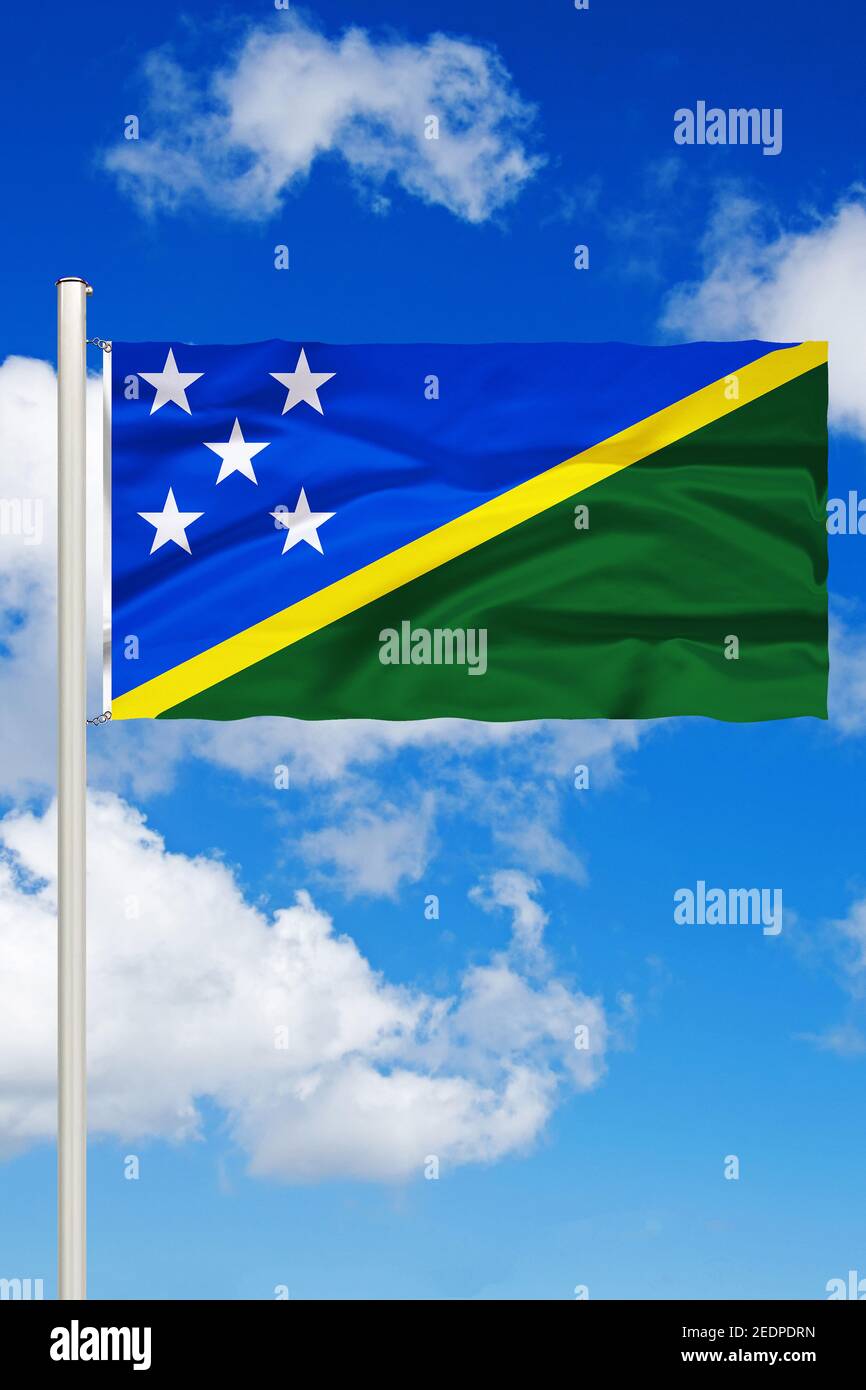 flag of Salomon Islands against blue cloudy sky, Salomon Islands Stock Photo